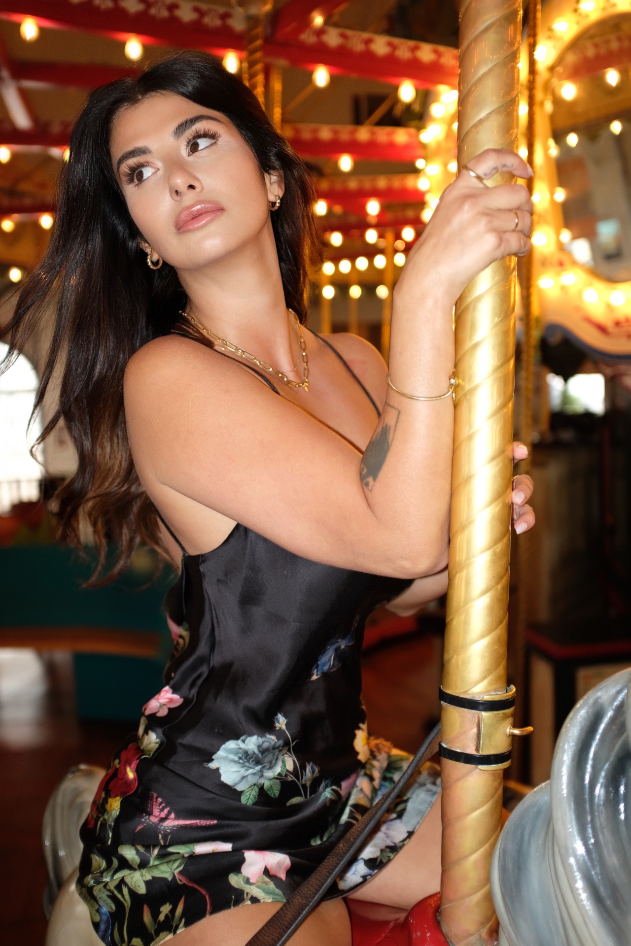 Veronica on a carousel in a silk floral dress
